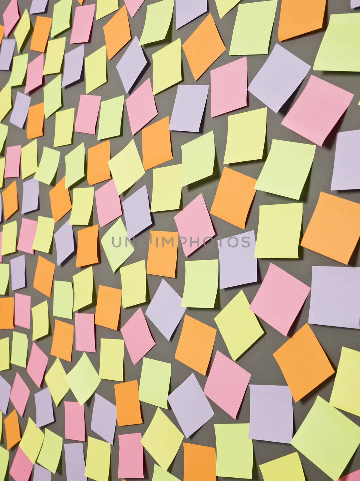 Adhesive Notes with different colors on grey background