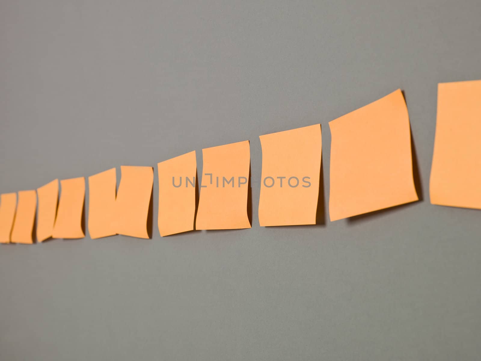 Orange Adhesive Notes in a row