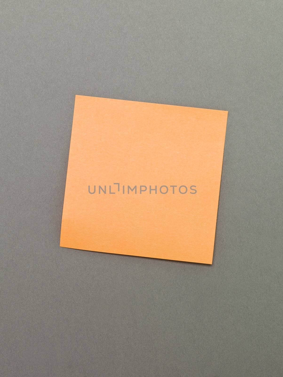 Orange Adhesive Note on grey background