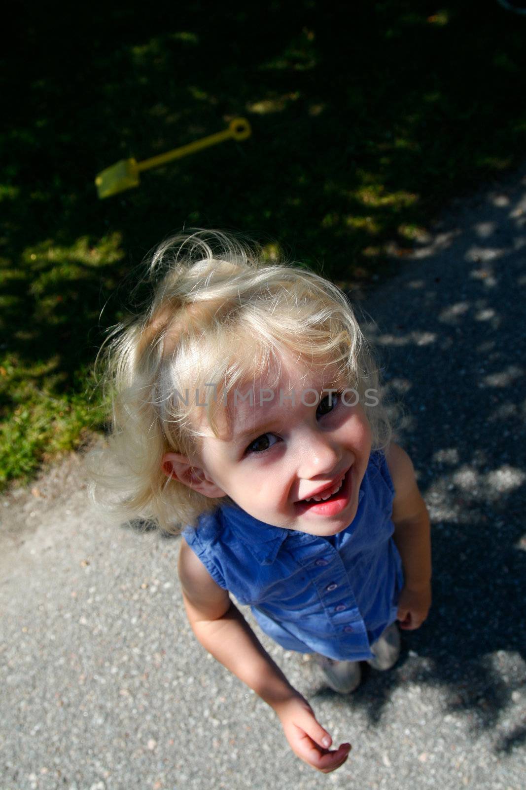 cute happy little girl looking upwards