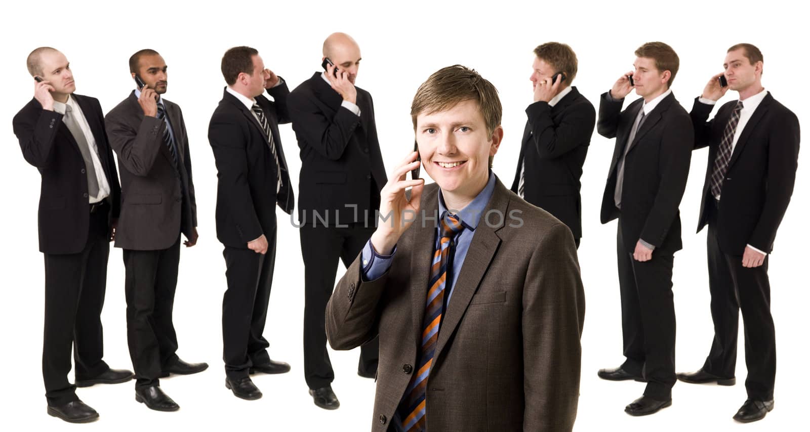 Business Manager on the phone in front of his team