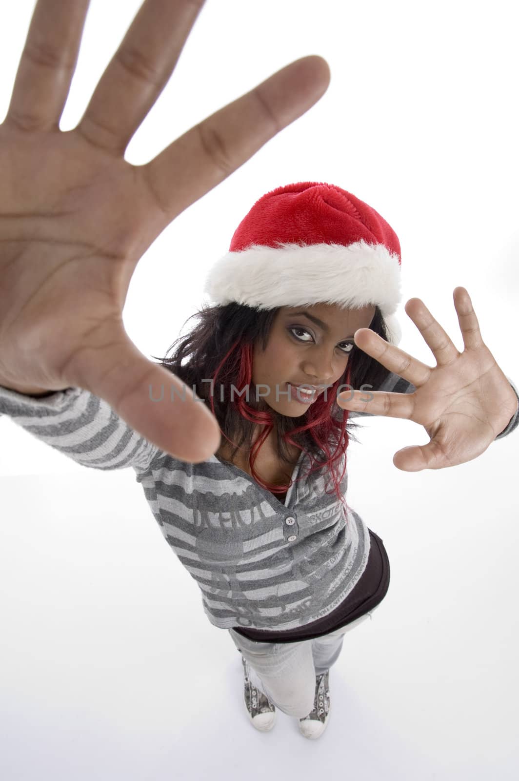 standing african girl with christmas hat on an isolated white background