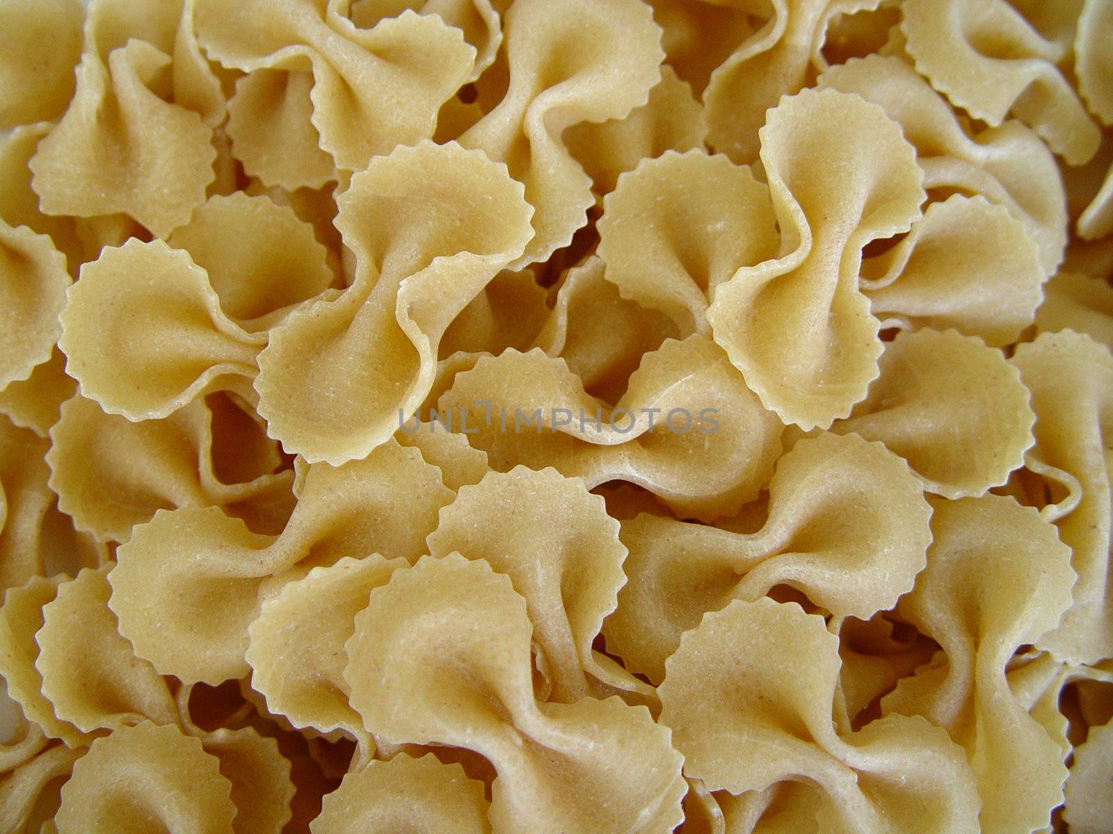 Raw pasta covering all the image background.         