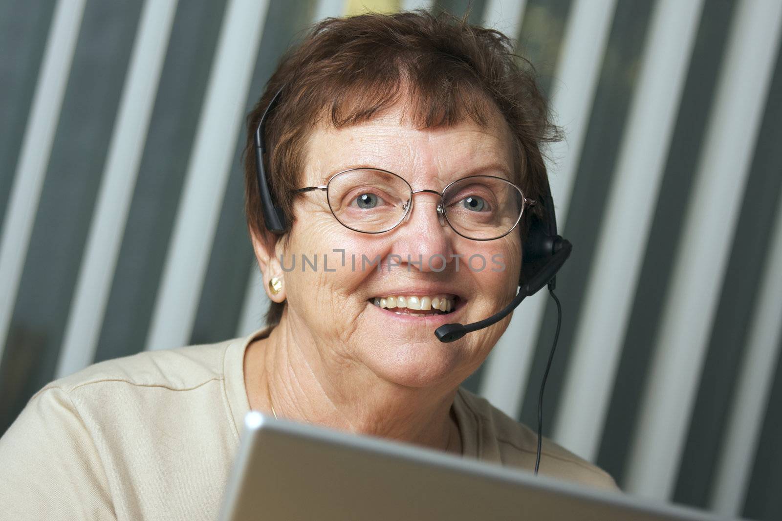 Smiling Senior Adult with Telephone Headset