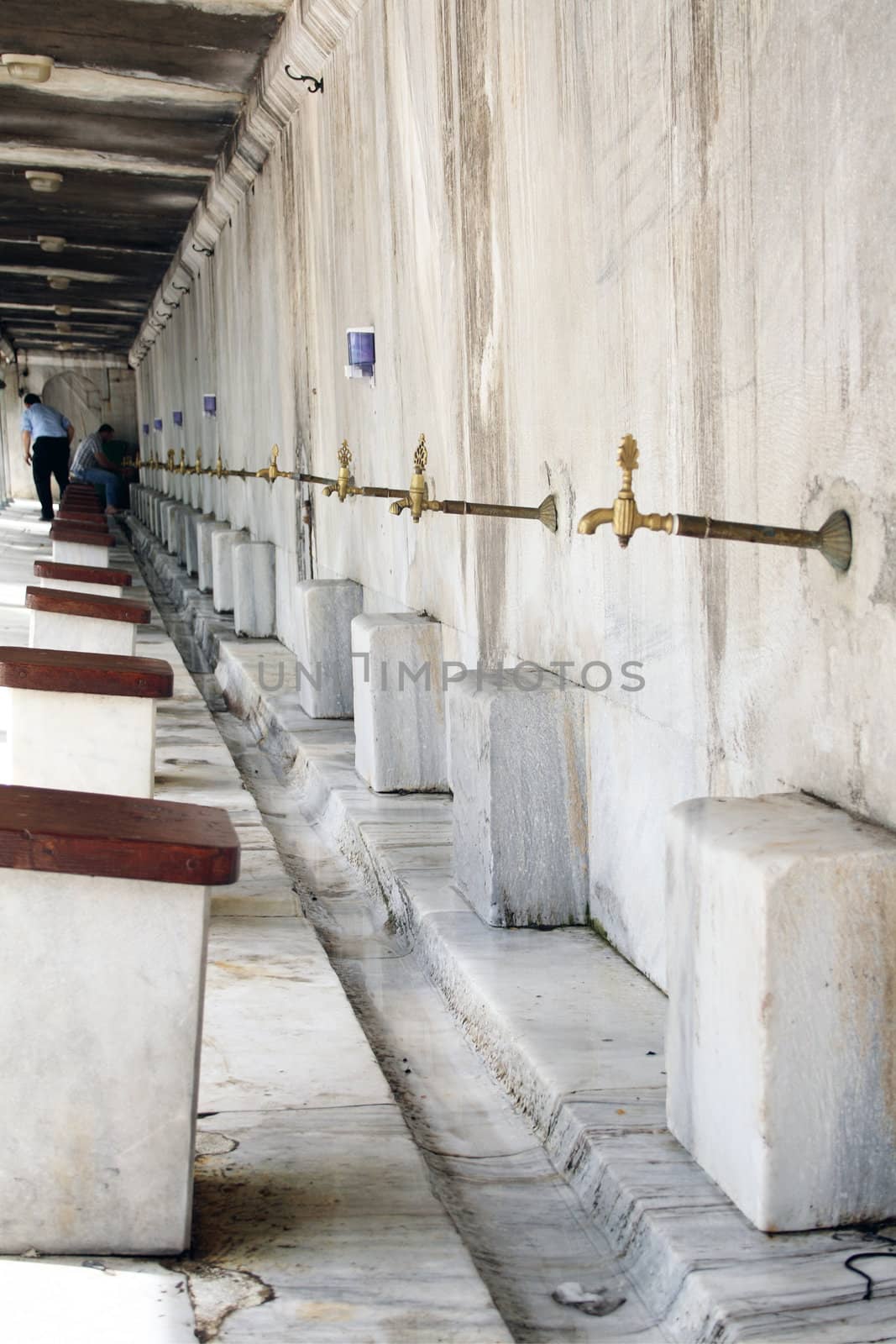 Ablutions on the marble fountain in courtyard fountain at The Sultanahmet Mosque (Bleu Mosque) in Istanbul