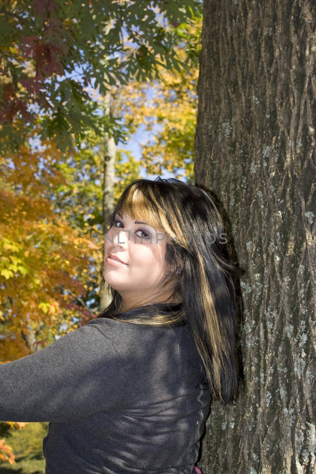 A young woman with highlighted hair in a new england setting during autumn.