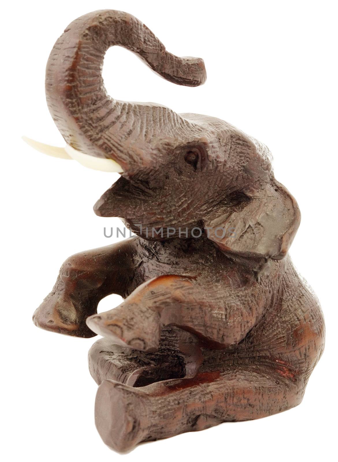 Deep-brown statuette of elephant a white background