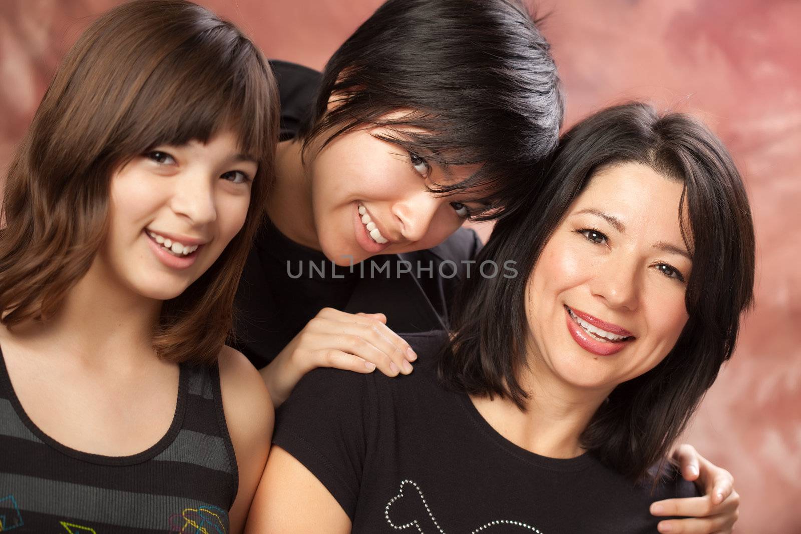 Attractive Multiethnic Mother and Daughters Studio Portrait.