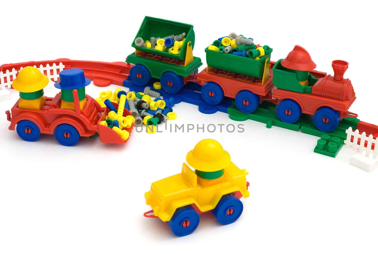 Toy railway with toy yellow machine on the white background