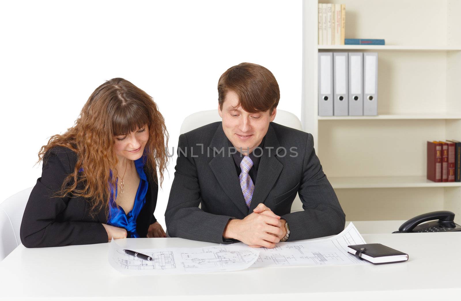 A man and a woman - engineers, working in the office