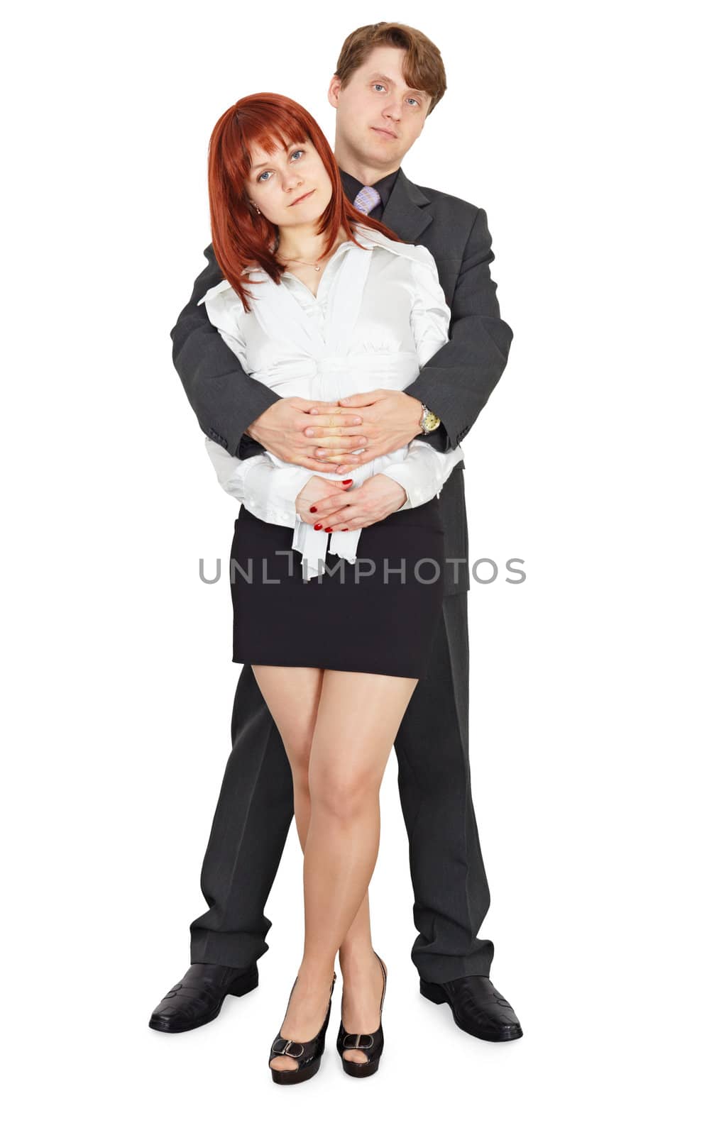 A young man embraces a beautiful girl on white