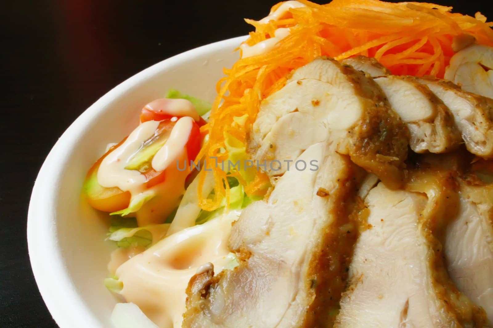 Salad With Chicken Slices on a Black Texture Table