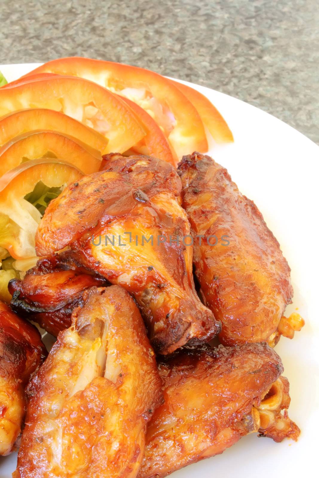 Chicken Wings on a White Plate with Vegetables