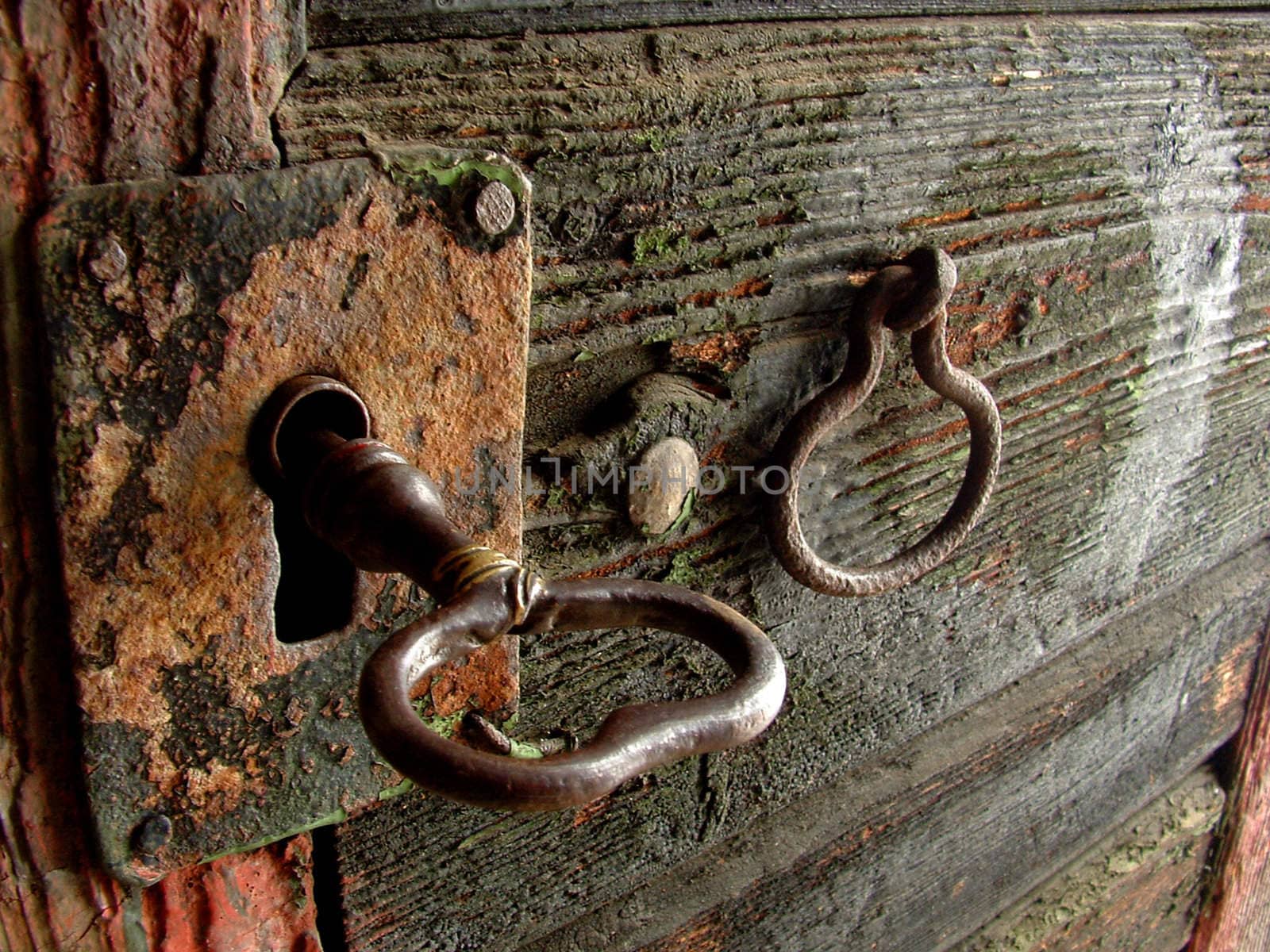 The door and key of a very old wine-cellar.