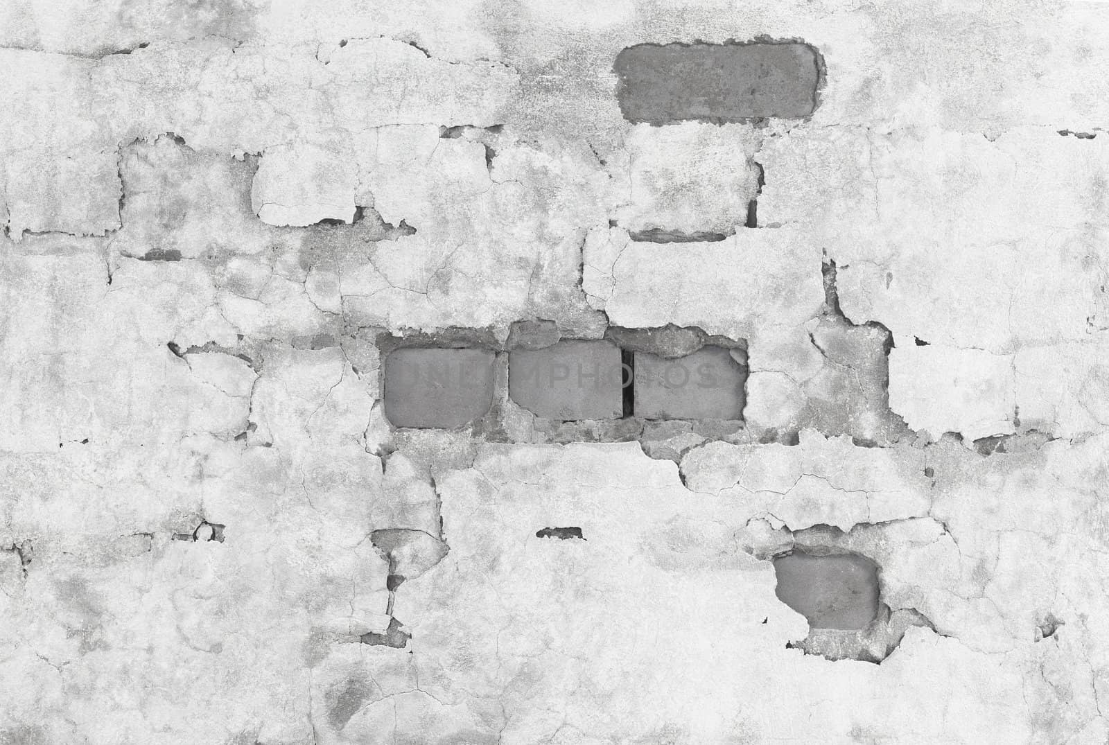 The brick wall are covered with broken plaster