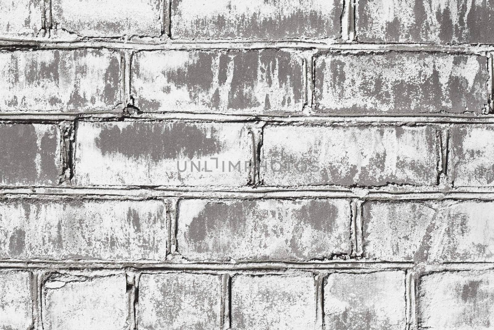 Wall from a grey brick damaged by a mould