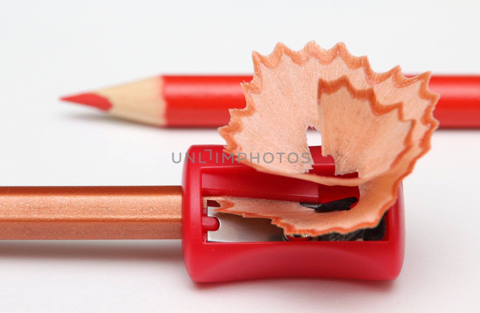 With a red pencil-sharpener and shavings.