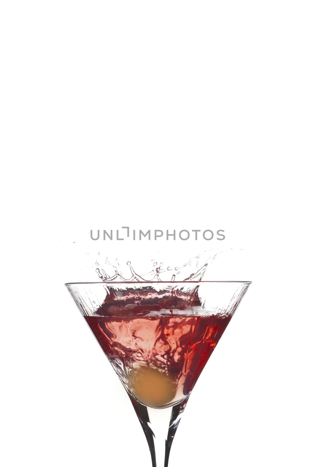 Cocktail splash with crown from olive on red martini with white background
