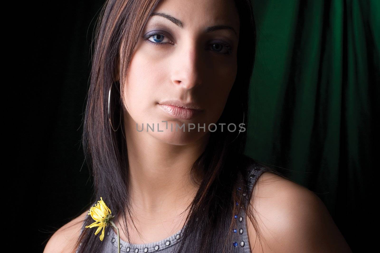 Twenty something fashion model holding dry flower