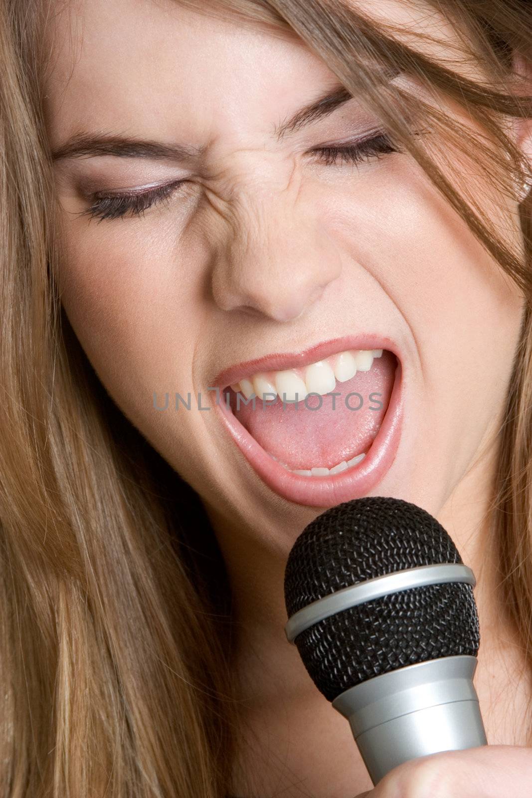 Pretty girl singing into microphone