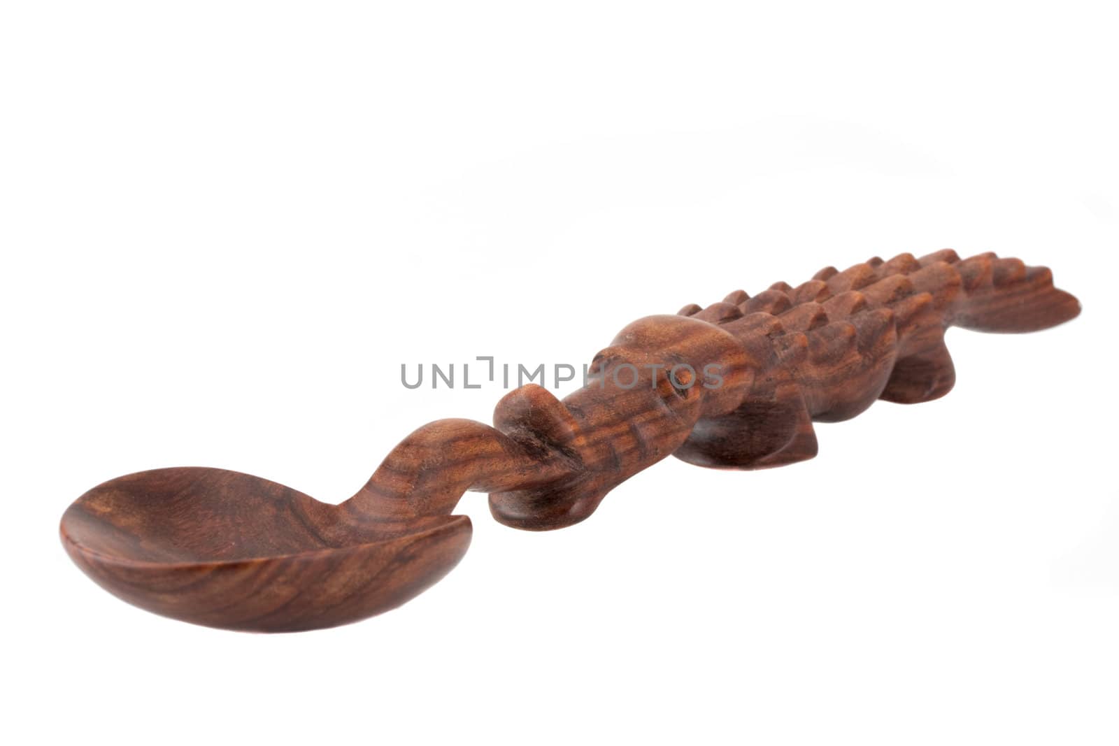 a carved spoon in the shape of a crocodile