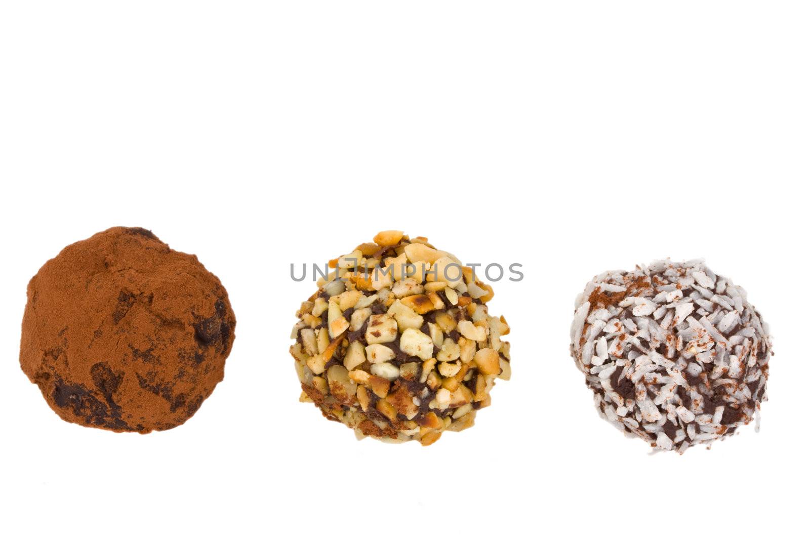 closeup of three home made chocolate pralines isolated on white background