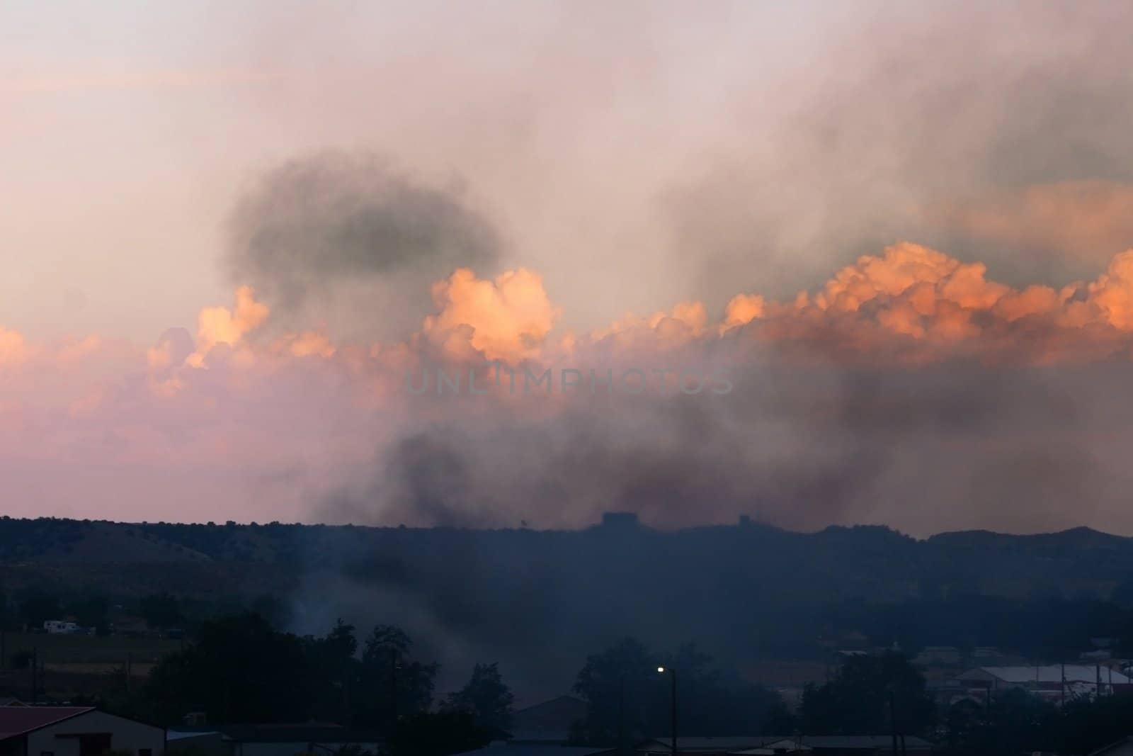 Smoke from out of control grassfire adds to the color of the sunset