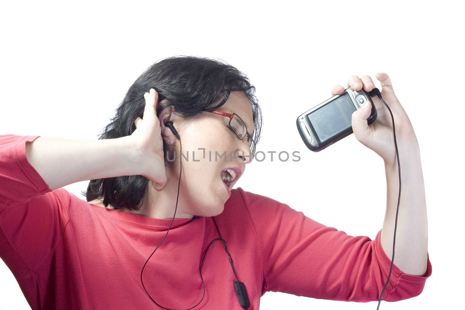 young woman listening, dancing and singing to music in a mp3 device