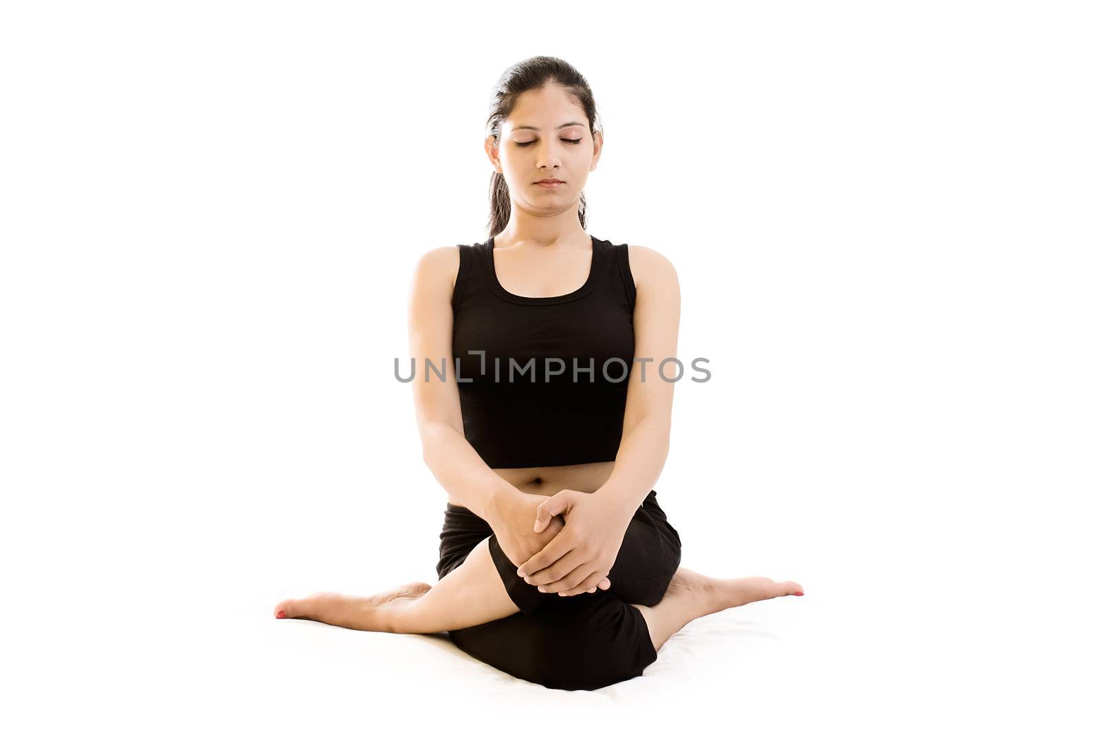 Young woman doing exercise over white background in black dress 