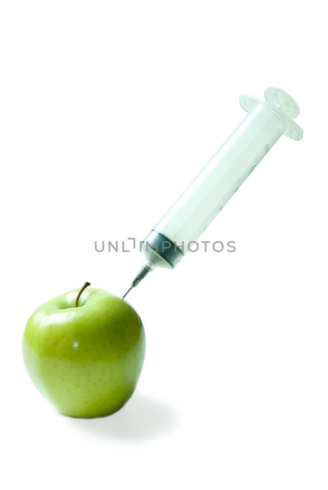 Concept image of a large needle injecting an apple with vitamins, isolated against a white background.