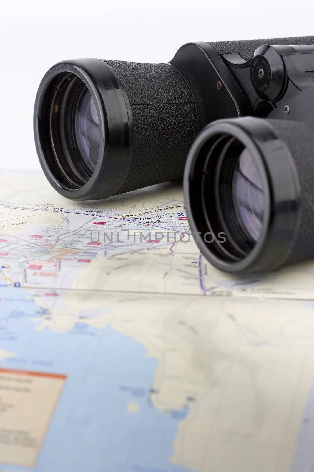 close up of a binoculars tool isolated over a map background