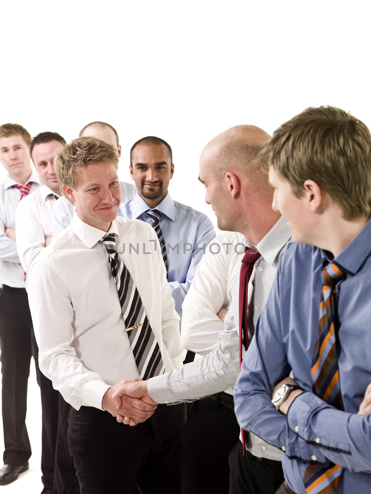 Businessmen shaking hands standing in a group