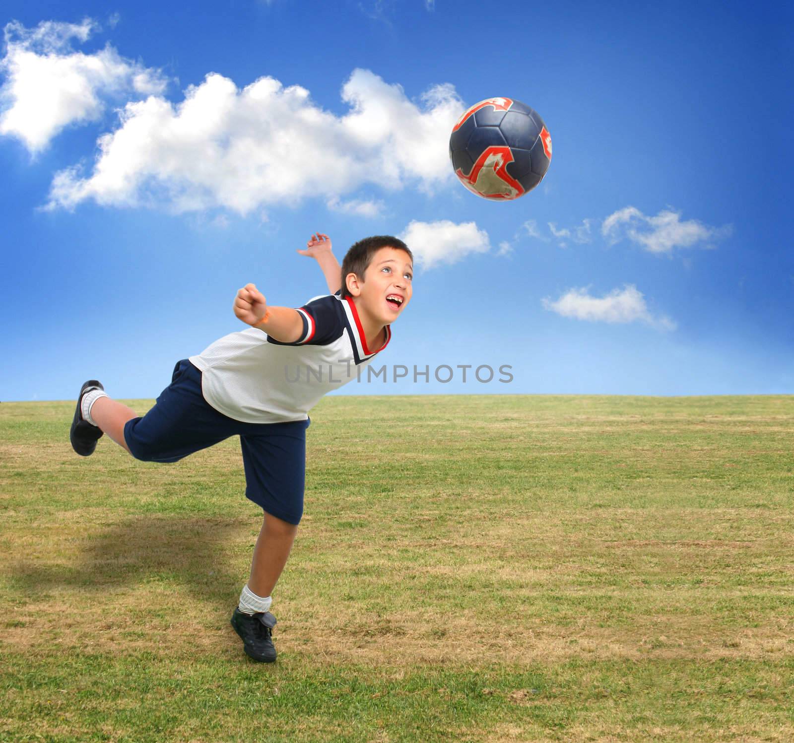 Kid playing soccer outside by Erdosain