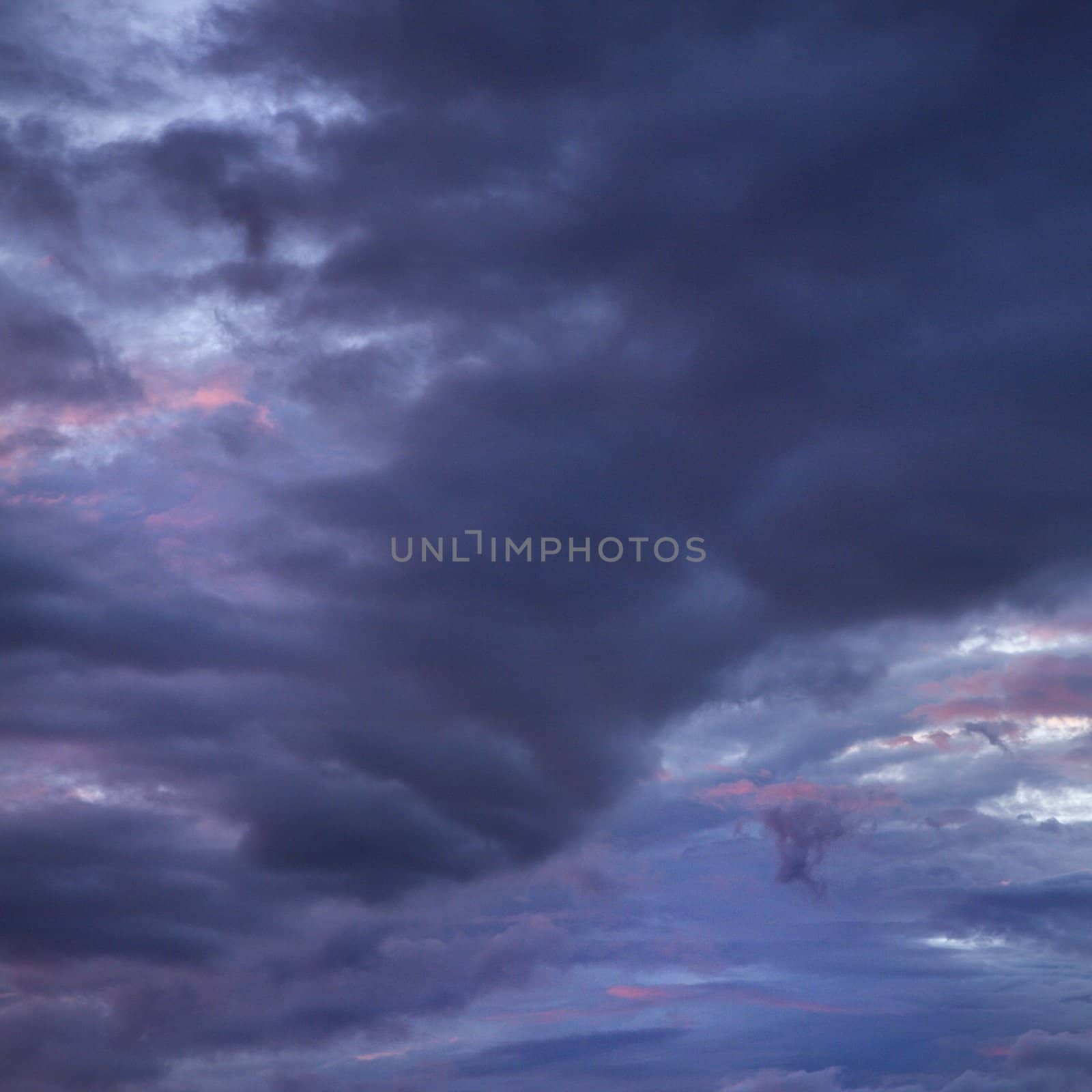 Dark ominous storm clouds spreading across Maui sky.