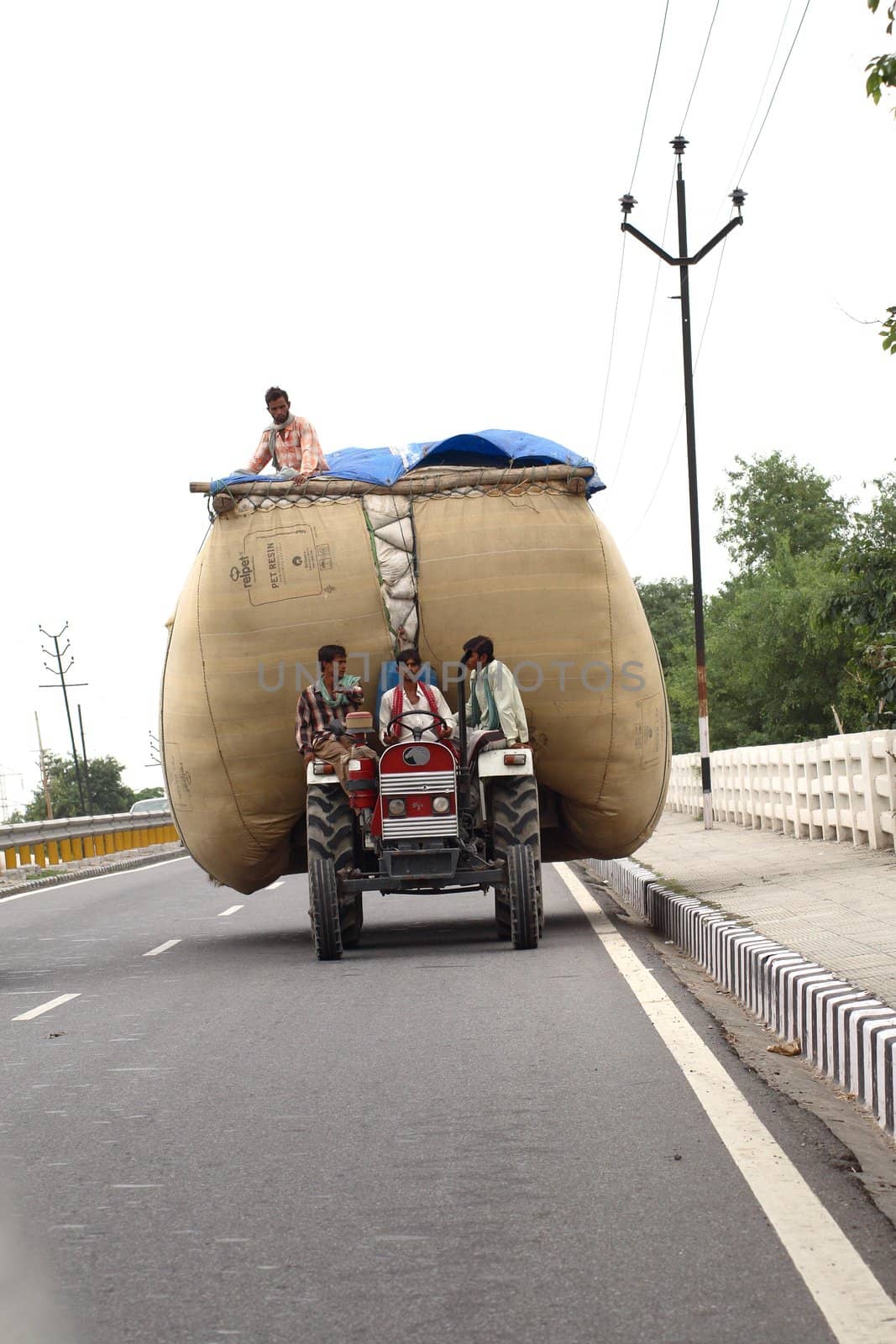 a road scene in India - small car with people and goods