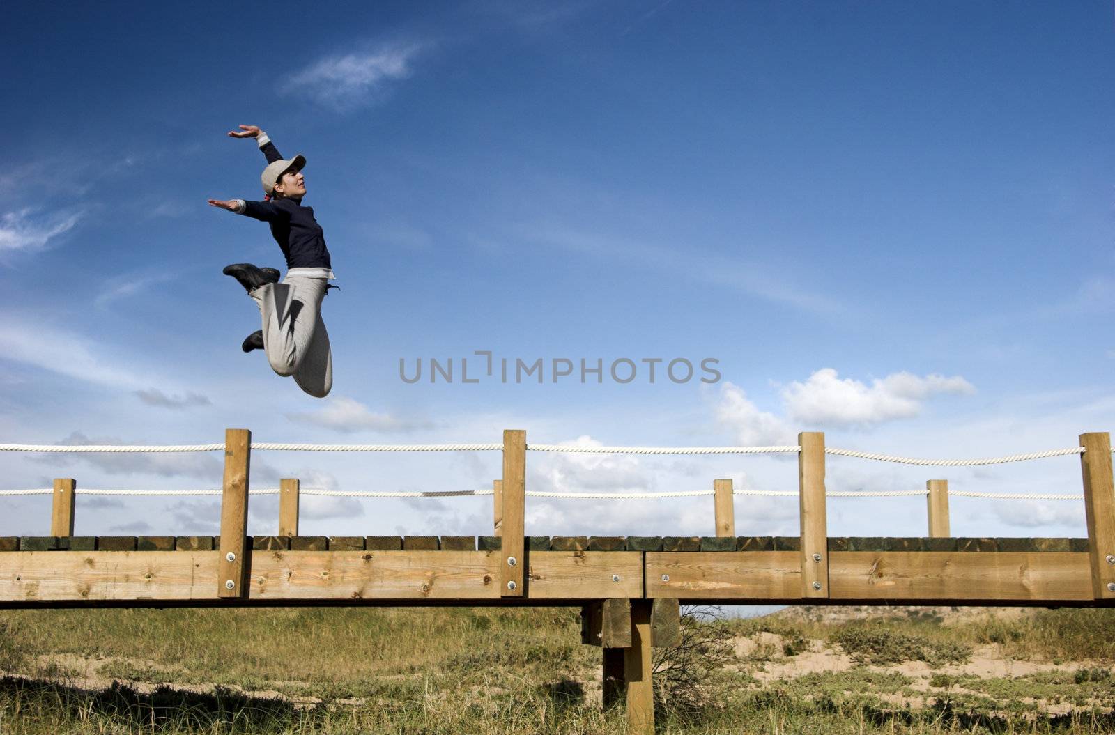 Young woman jumping for fun in a beautiful day