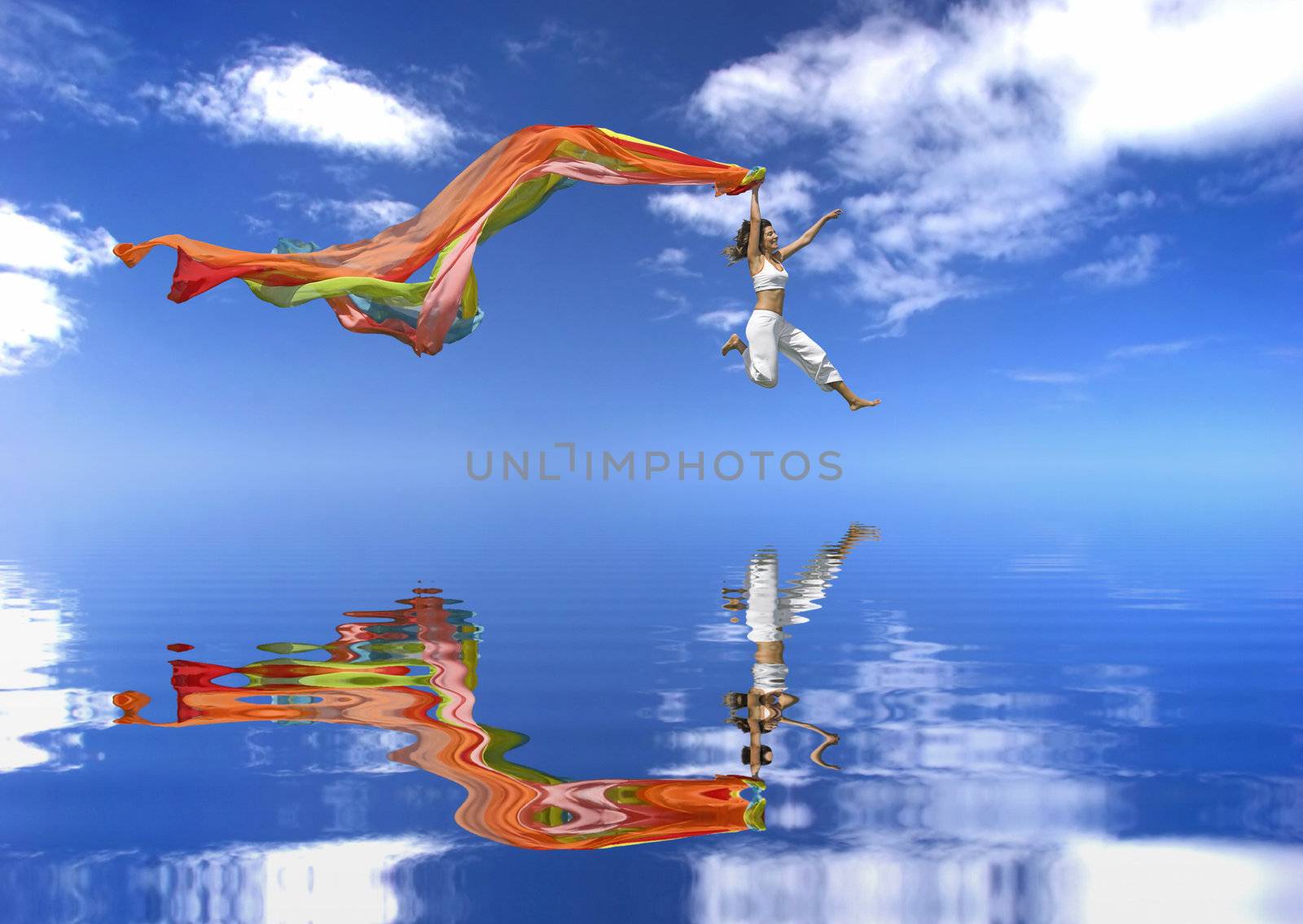 Beautiful woman jumping with a Scarf over a beautiful blue sky with clouds