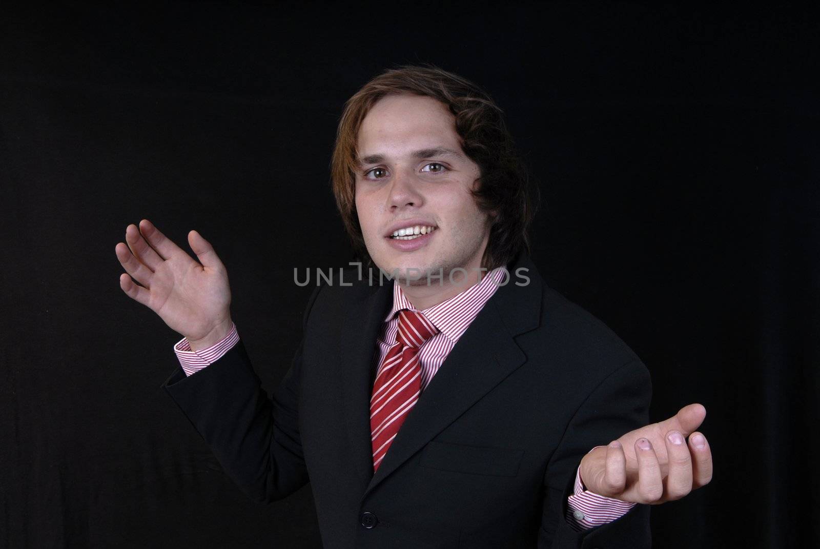 young business man portrait on black background