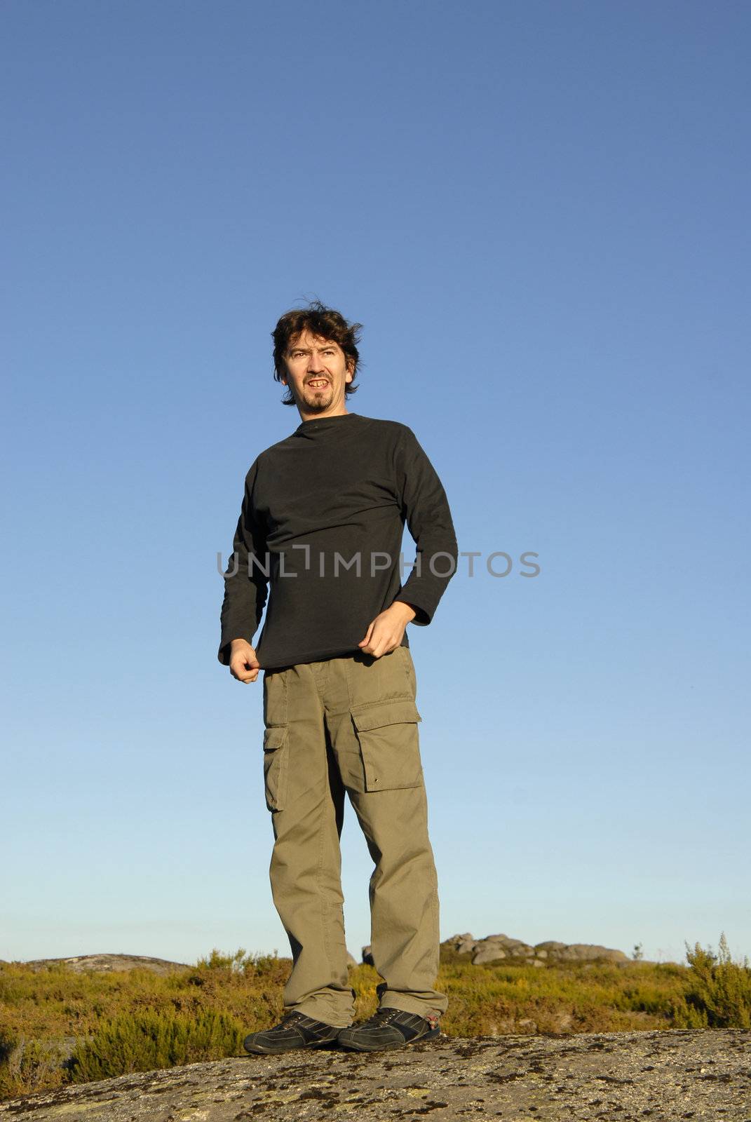 man on a rock and the sky as background