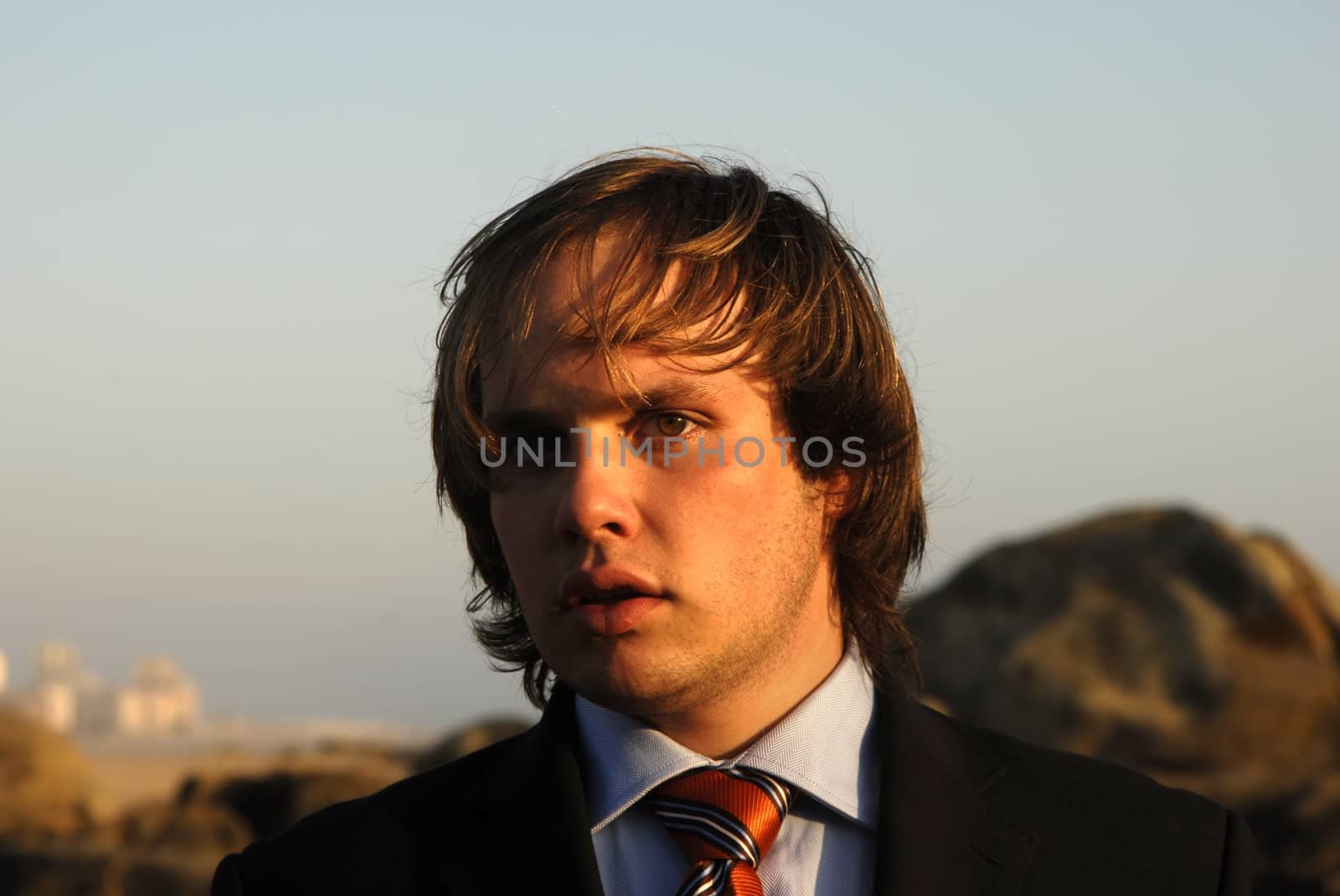 man portrait with suit outdoors in sunset light