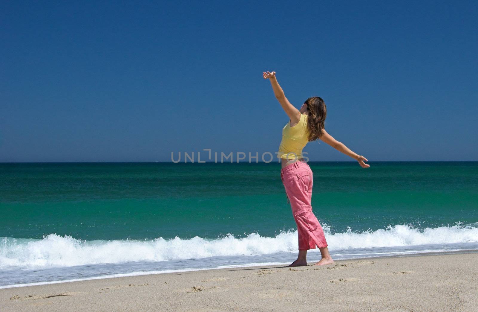 Beautiful woman making poses in the beach by Iko