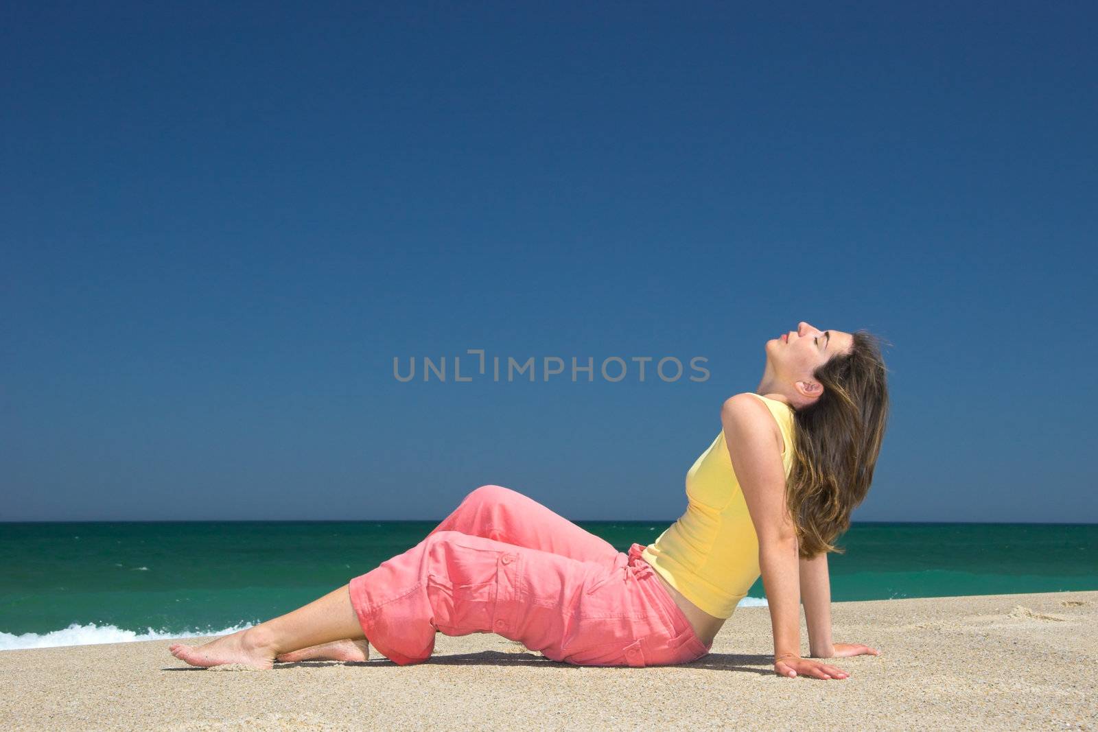 Beautiful young woman relax in the beach by Iko