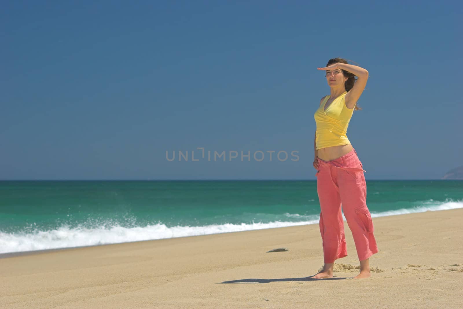 Beautiful woman in the beach watching