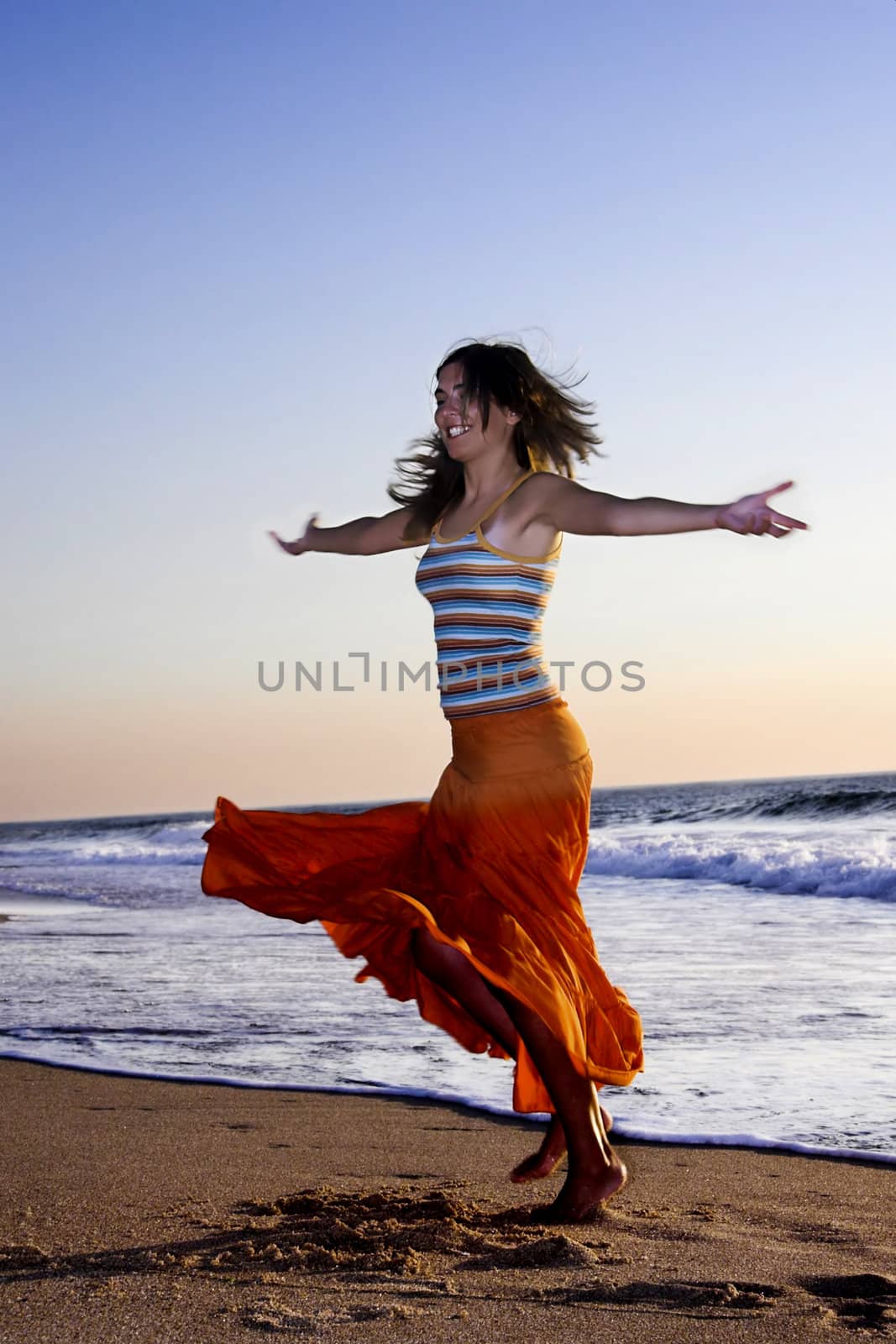 Beautiful woman dancing in the beach