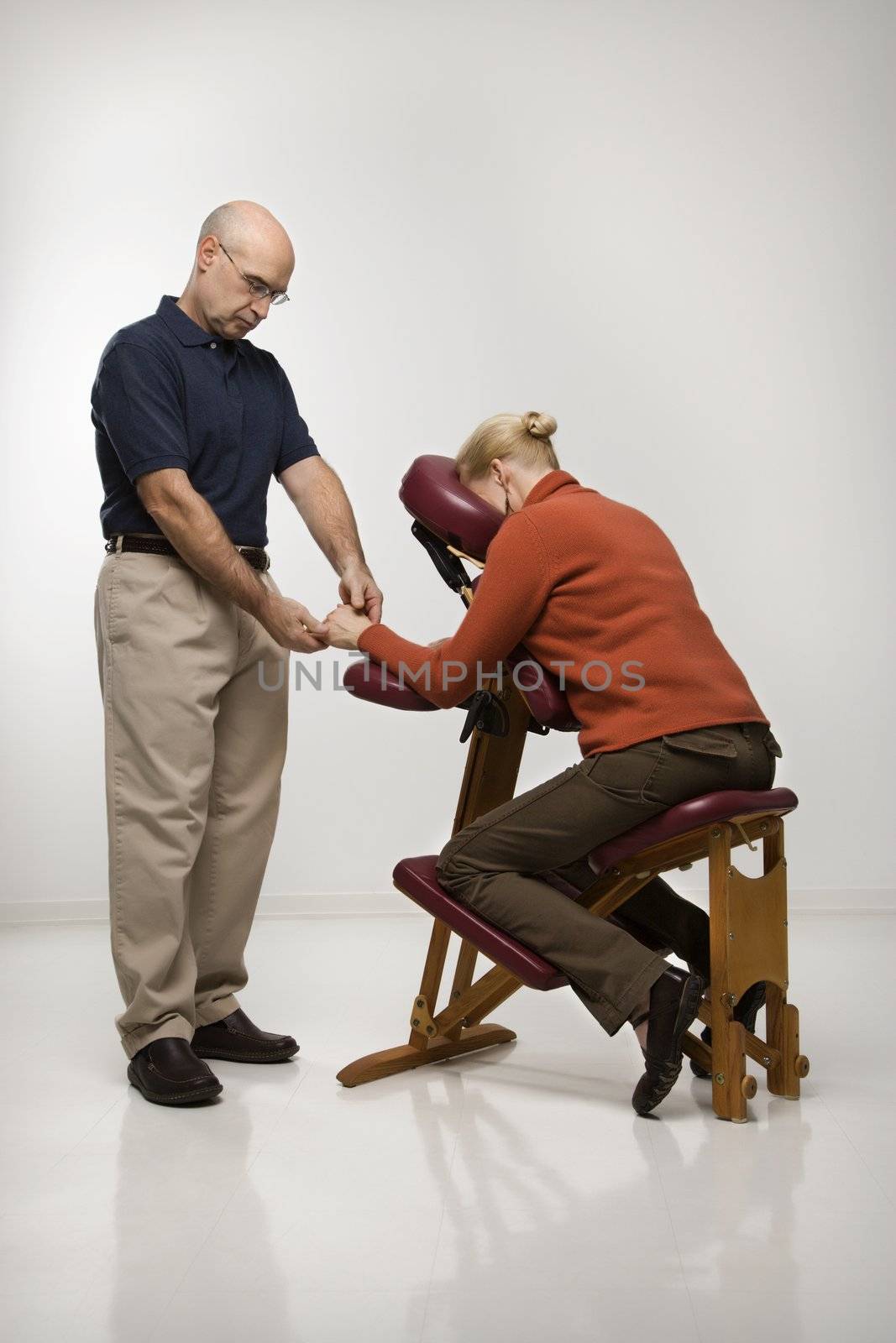 Man massaging woman. by iofoto