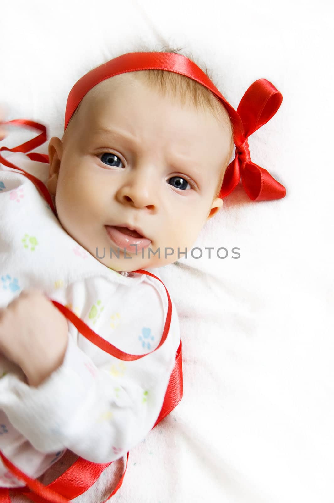 Cute baby girl with red ribbon