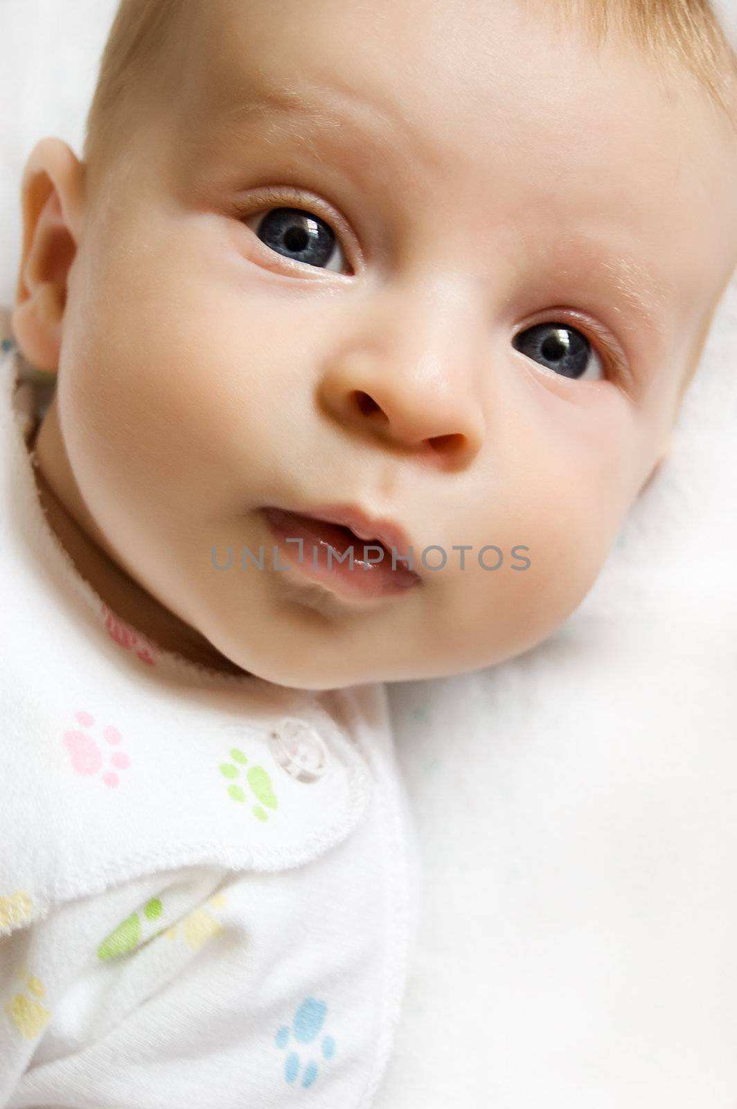 Cute baby girl lying on bed