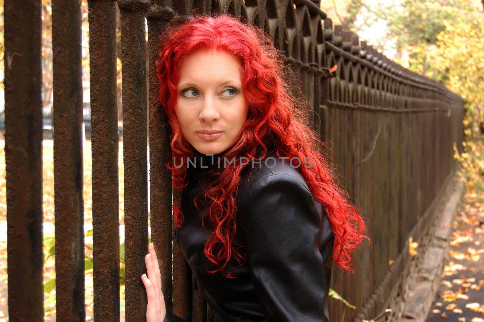 gothic style red hair woman near grate