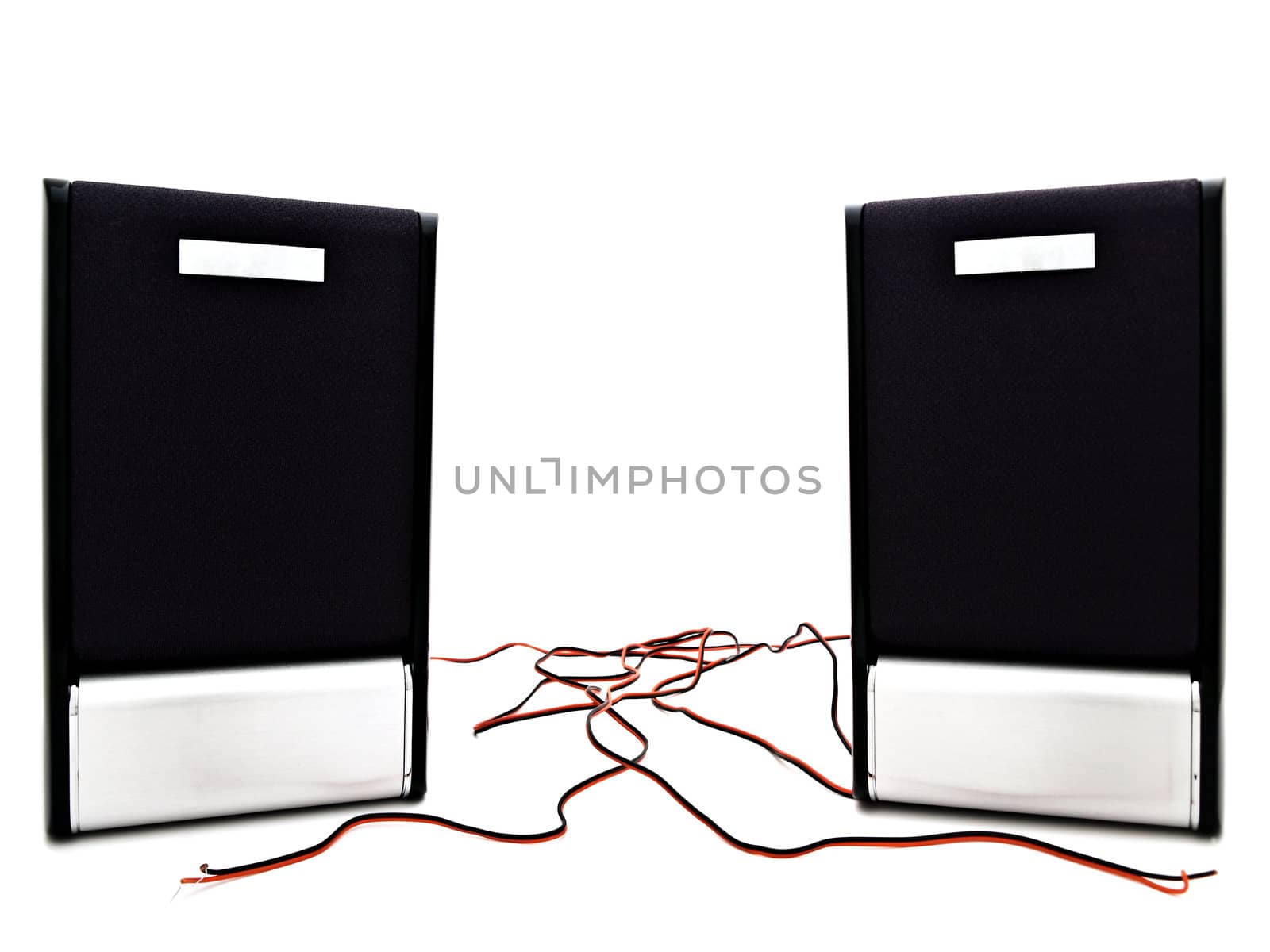 two modern loudspeakers with wires against the white background