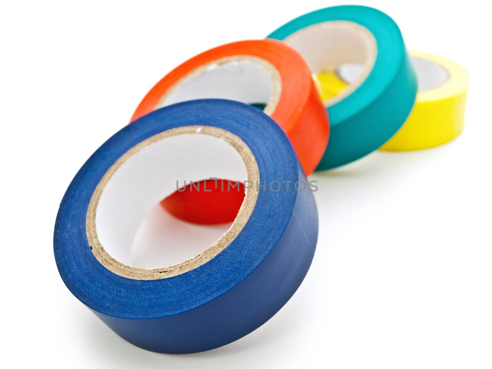 Photo of some multicolored insulating tapes against the white background